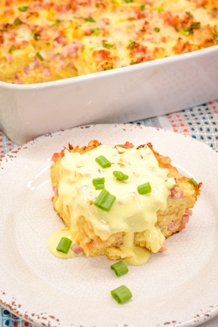 Eggs Benedict casserole that is made with English muffins, ham, eggs, and topped off with an easy blender hollandaise sauce.