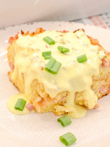 Eggs Benedict casserole that is made with English muffins, ham, eggs, and topped off with an easy blender hollandaise sauce.