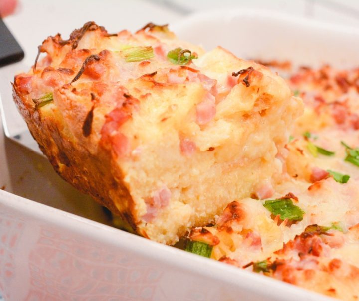 Eggs Benedict casserole that is made with English muffins, ham, eggs, and topped off with an easy blender hollandaise sauce.