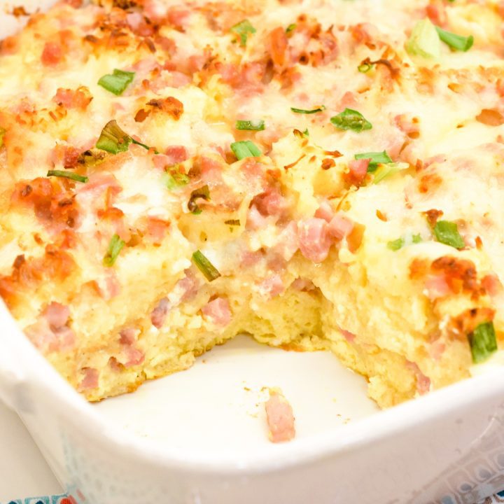 Eggs Benedict casserole that is made with English muffins, ham, eggs, and topped off with an easy blender hollandaise sauce.