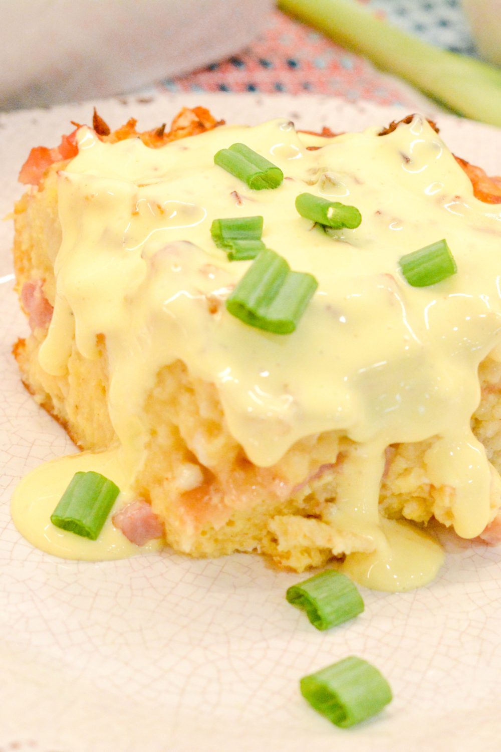 Eggs Benedict casserole that is made with English muffins, ham, eggs, and topped off with an easy blender hollandaise sauce.