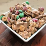 This White Chocolate Candy Mix features some of our favorite cereals, salty snacks and candy. Covered in almond bark (white chocolate), this candy mix is often called White Trash Mix.