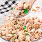 Let’s ring in some holiday cheer with this Christmas Puppy Chow recipe! This snack mix, also known as muddy buddy mix, is an easy party favorite around here.