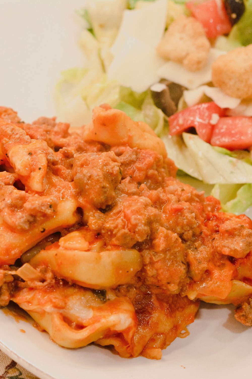 This pasta casserole recipe is a red meat sauce with cheese filled tortellini casserole topped with cheese and make the best baked tortellini.