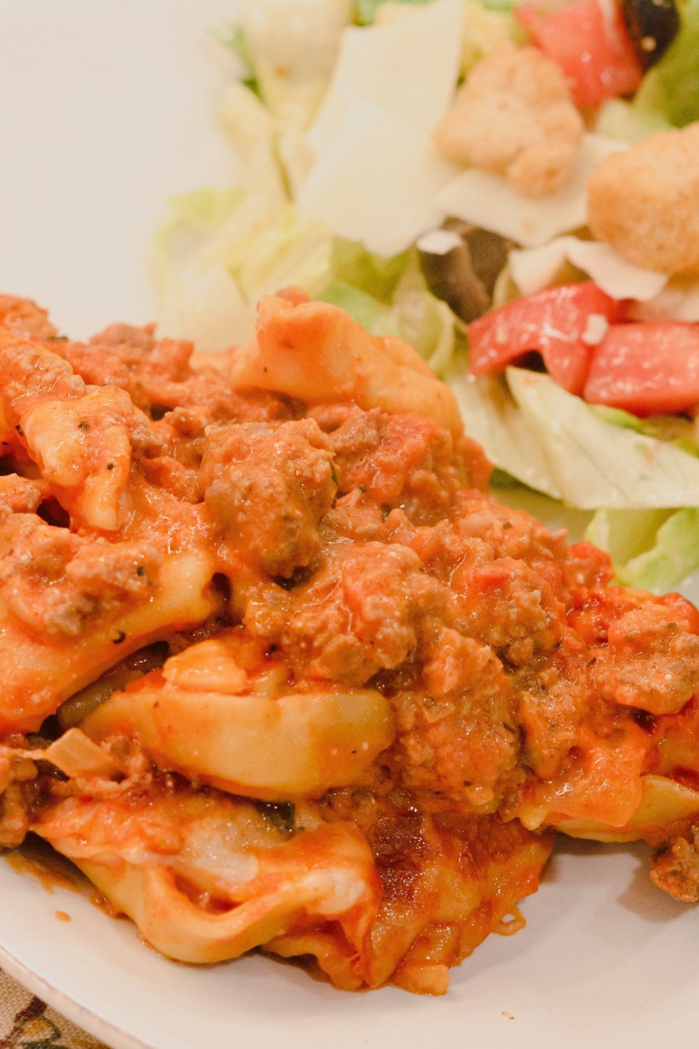 This pasta casserole recipe is a red meat sauce with cheese filled tortellini casserole topped with cheese and make the best baked tortellini. 