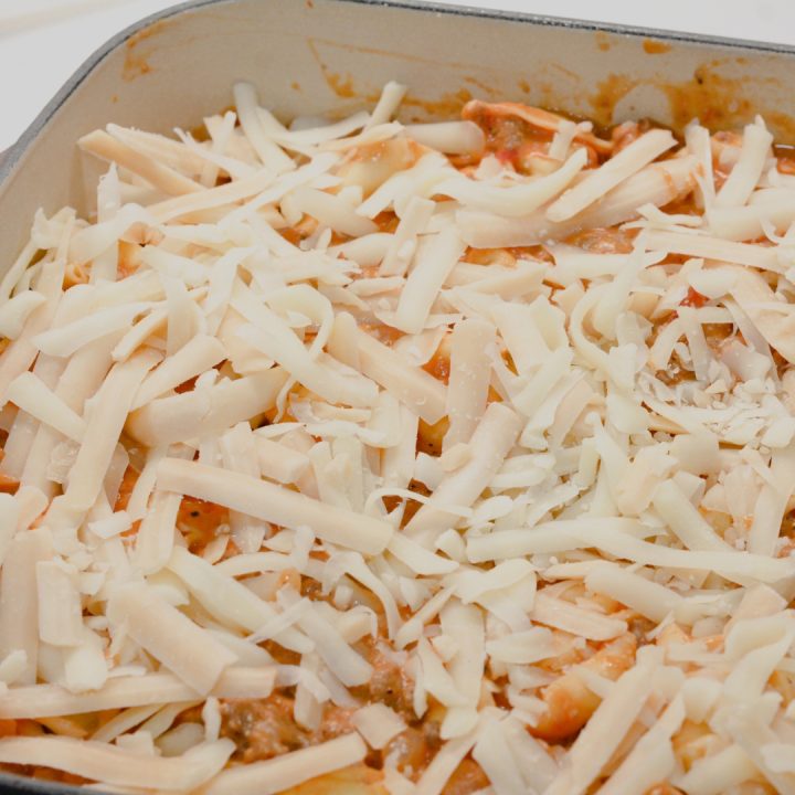 Transfer to a 13x9 pan to bake. Top with shredded cheese. Cover tightly with aluminum foil and bake at 350 degrees for 30-45 minutes. Uncover for 5 minutes to allow the cheese to brown.