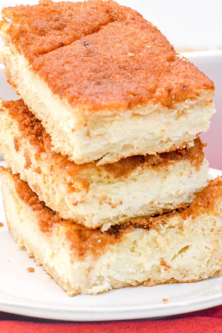 Snickerdoodle cookies and cheesecake combine for these snickerdoodle cheesecake bars made with a double crust of crescent rolls for yummy cinnamon cream cheese bars.