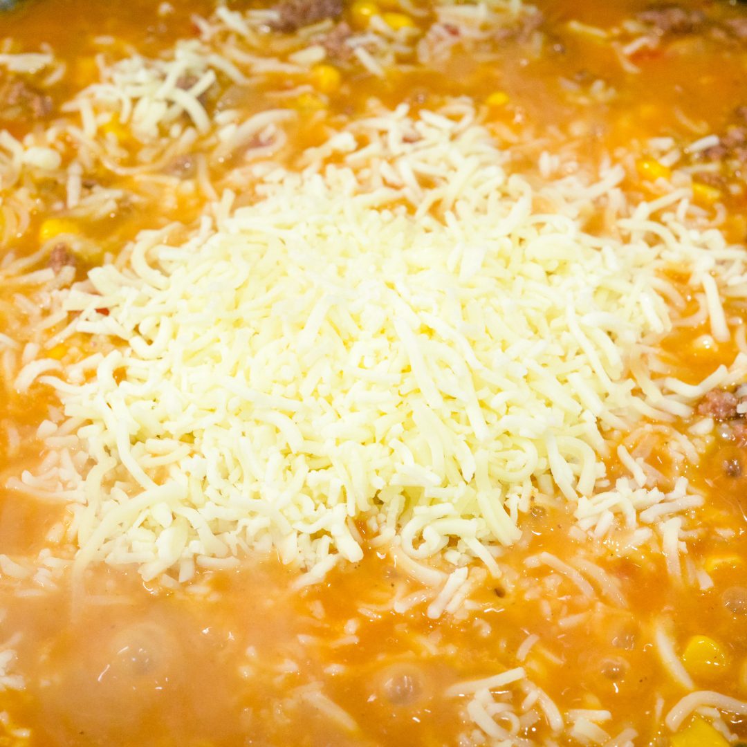 To the browned ground beef, add the rice, flavor packets, canned ...