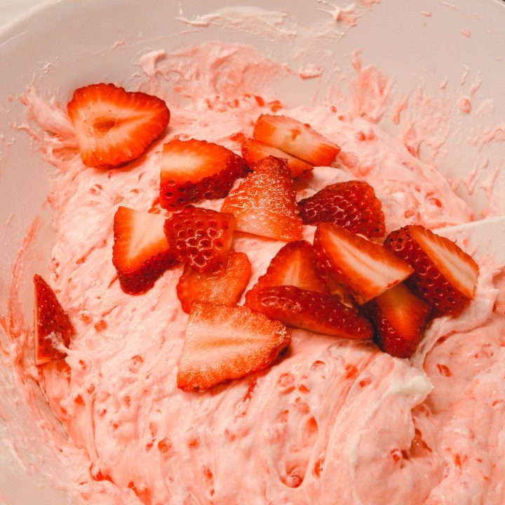 Stir in the fresh strawberries to the cool whip and jello.