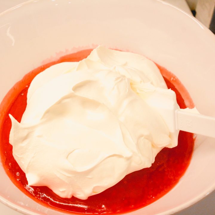 After the strawberry tapioca jello has cooled for a few hours, stir in the cool whip.