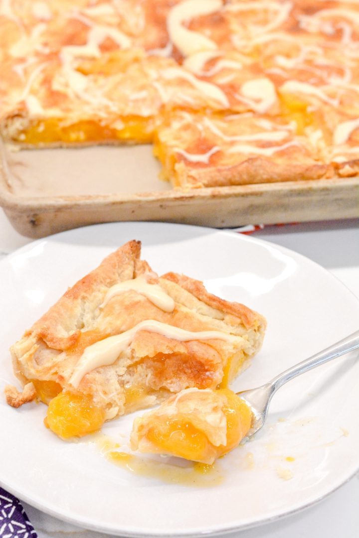 Bourbon peach slab pie is a peach pie bars recipe that is just like a slice of peach pie that is even better topped with brown sugar glaze.