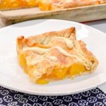 Bourbon peach slab pie is a peach pie bar recipe that is just like a slice of peach pie that is even better topped with brown sugar glaze or ice cream.