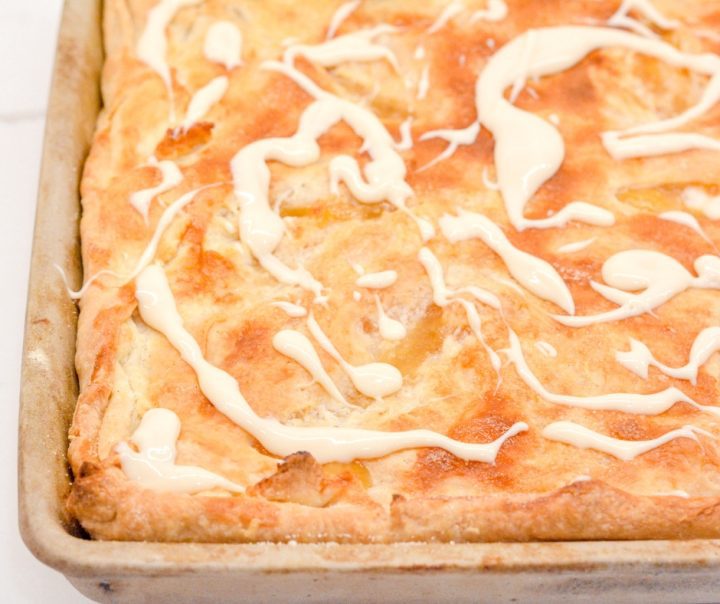 Bourbon peach slab pie is a peach pie bar recipe that is just like a slice of peach pie that is even better topped with brown sugar glaze or ice cream.