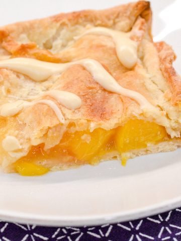 Bourbon peach slab pie is a peach pie bars recipe that is just like a slice of peach pie that is even better topped with brown sugar glaze.