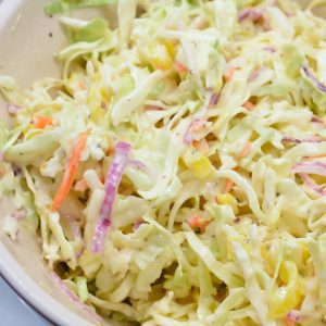 Stir coleslaw to combine all the ingredients. Be sure to dig deep in the bowl to get the cabbage completely coated.