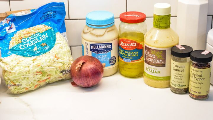 Italian Coleslaw ingredients - coleslaw mix, red onion, banana rings, mayonnaise, Italian dressing, Italian seasoning, red pepper flakes