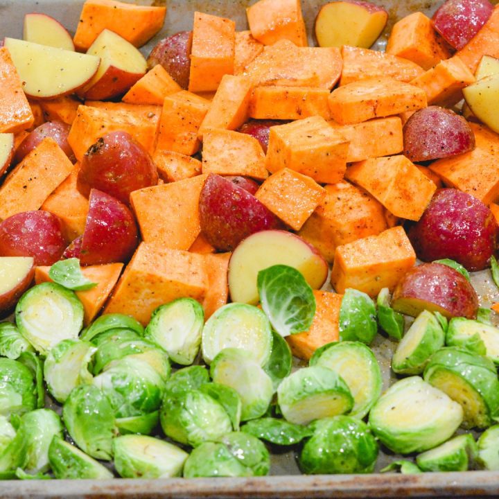 Cut up the Brussels Sprouts by cutting the bottom off and cutting in half. Dump the potatoes on a sheet pan with the Brussels Sprouts. Coat in the oil and seasoning