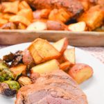 The sheet pan pork tenderloin is rubbed in a sweet and spicy dry rub that is sprinkled on the cut-up sweet potatoes, red potatoes, and Brussels sprouts before it is oven baked.