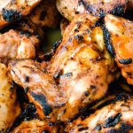 Grilled Buffalo Chicken is made by marinading chicken in a hot sauce, barbecue sauce, and ranch dressing before grilling.