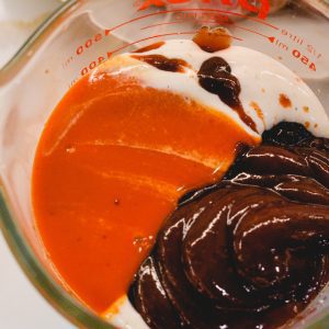 Make this barbecue buffalo sauce marinade by combining Buffalo sauce, barbecue sauce, and ranch salad dressing.