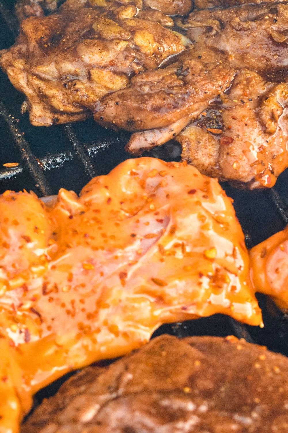 Grilled Buffalo Chicken is made by marinading chicken in a hot sauce, barbecue sauce, and ranch dressing before grilling.