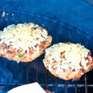 Let the pork burgers cook for 5-7 minutes before flipping. Flip and cook for another 5 minutes. Top with cheese before pulling off the grill.