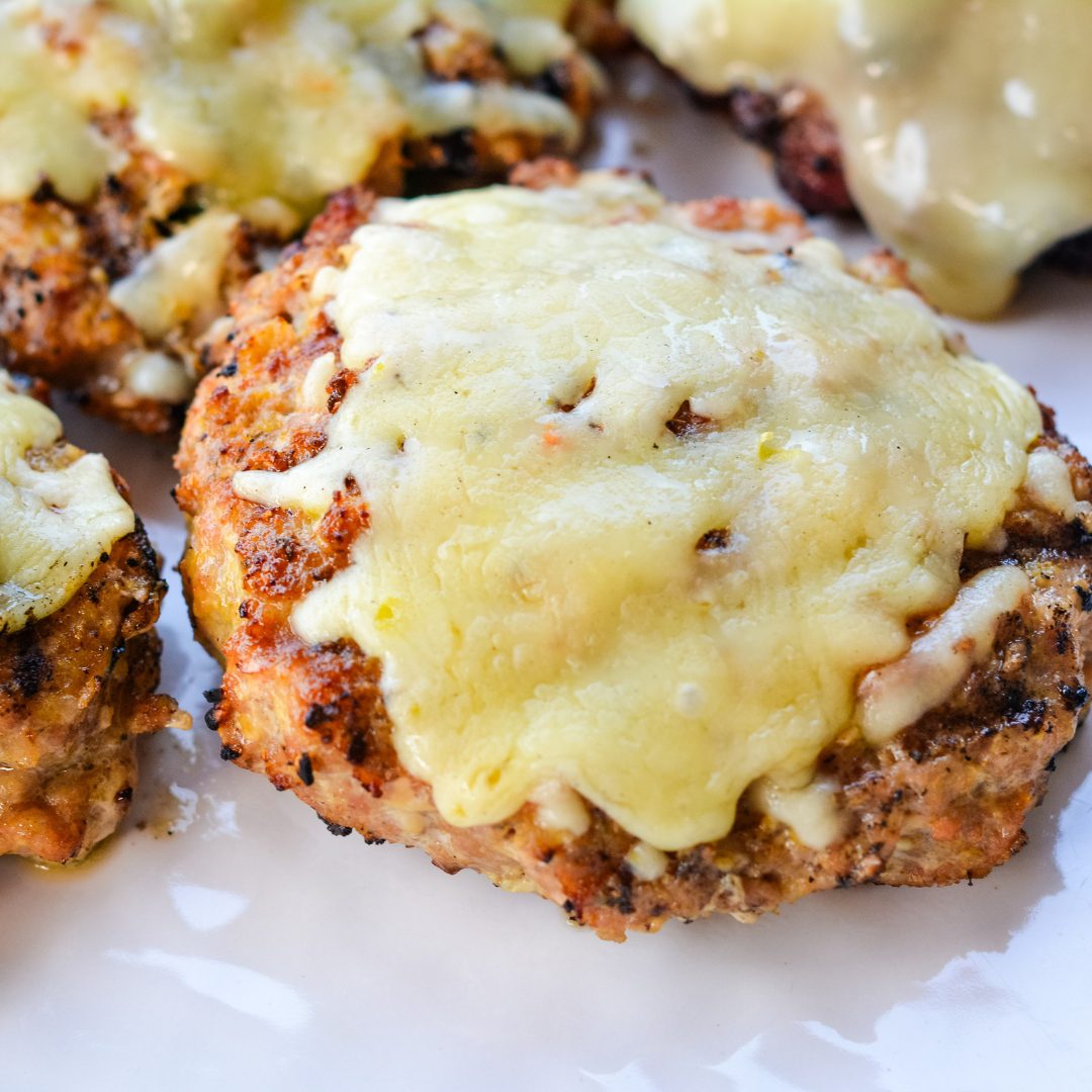 Let the pork burgers cook for 5-7 minutes before flipping. Flip and cook for another 5 minutes. Top with cheese before pulling off the grill.