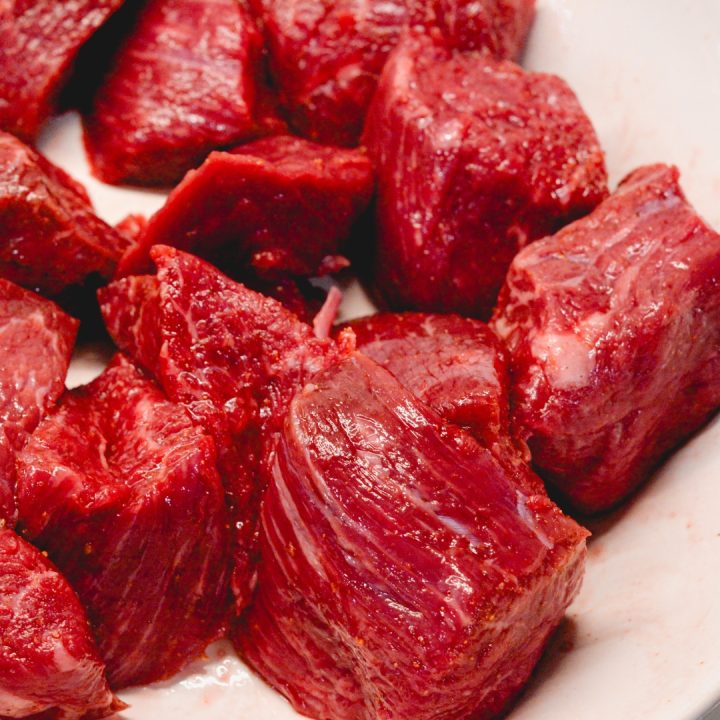 Cut the steaks into roughly 3-inch by 3-inch pieces and season with cajun seasoning.