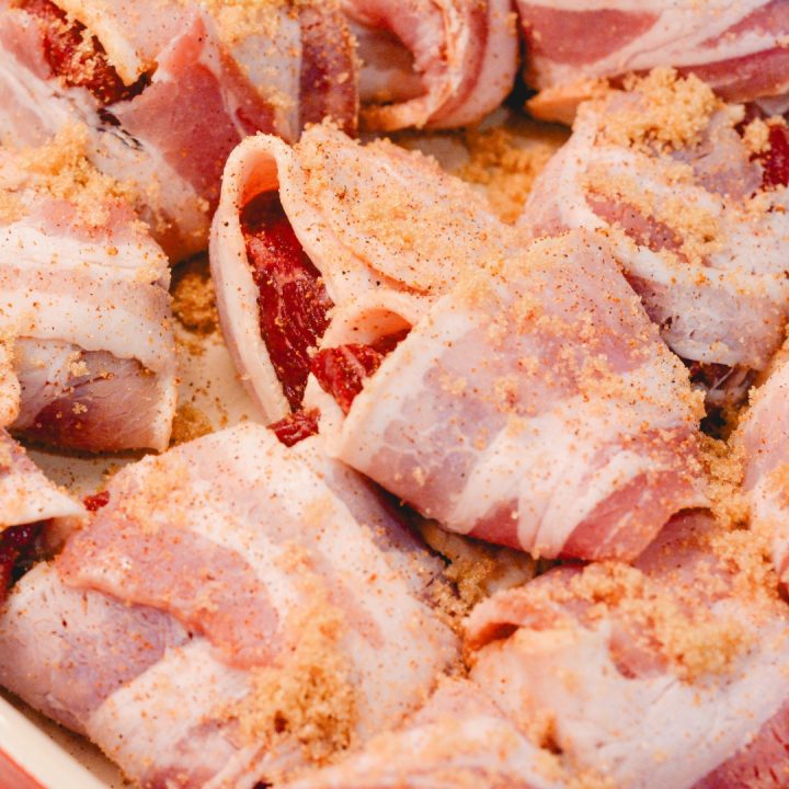 Season the bacon-wrapped steak bites with cajun and brown sugar.