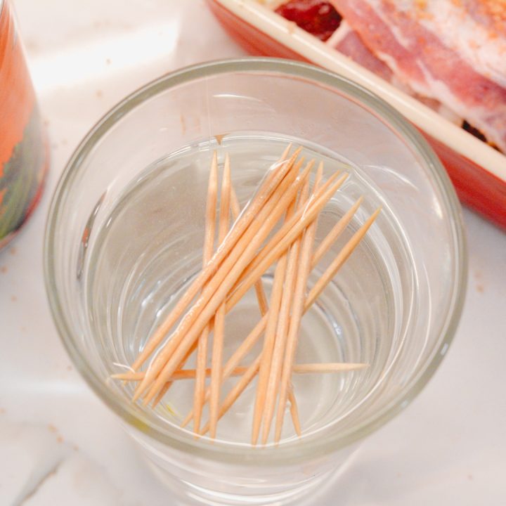 Soak toothpicks in water so they don't burn up immediately. These are needed to hold the bacon in place.