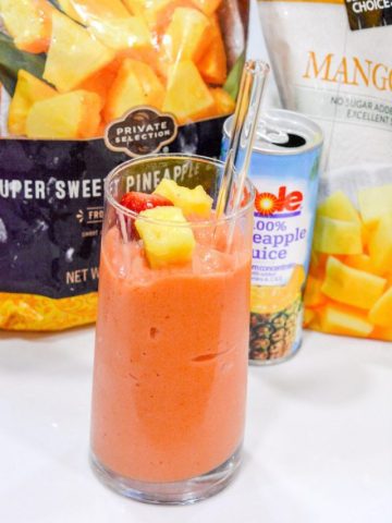 A combination of frozen strawberries, frozen pineapple, and frozen mango with orange and pineapple juice makes the best Tropical Smoothie Cafe Sunrise Sunset smoothie.