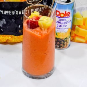 A combination of frozen strawberries, frozen pineapple, and frozen mango with orange and pineapple juice makes the best Tropical Smoothie Cafe Sunrise Sunset smoothie.