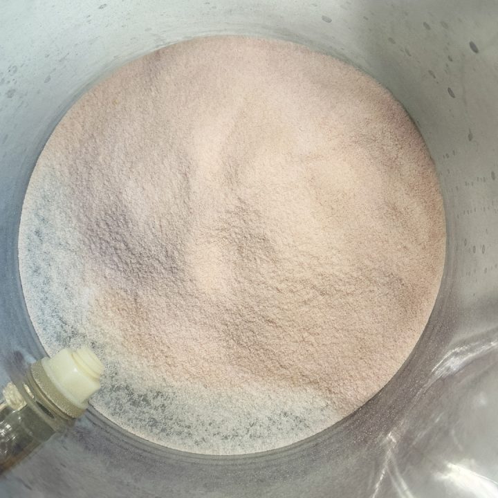 Add the powdered pink lemonade mix to the drink container.