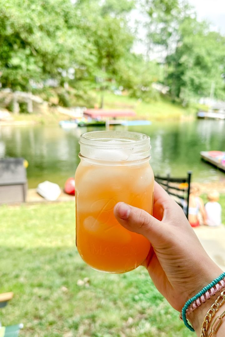 When the pink Country Time lemonade is mixed with the yellow of the pineapple juice, a fun orange punch is created with this pineapple lemonade punch that is slightly tart, and slightly sweet with a little fizz from ginger ale.