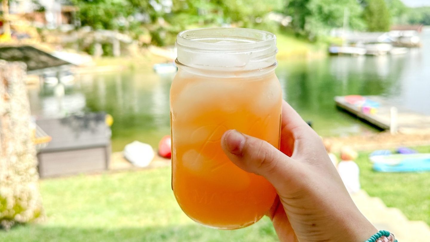 When the pink Country Time lemonade is mixed with the yellow of the pineapple juice, a fun orange punch is created with this pineapple lemonade punch that is slightly tart, and slightly sweet with a little fizz from ginger ale.