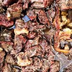 Smoked beef chuck roast will quickly become one of your favorite cuts of beef to smoke with a simple beef rub made with garlic, salt, and pepper and then finished in a pan of onions and beef broth.