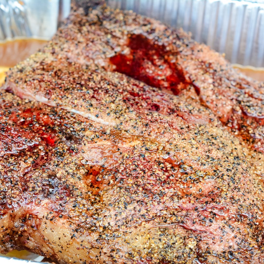 Smoked beef chuck roast will quickly become one of your favorite cuts of beef to smoke with a simple beef rub made with garlic, salt, and pepper and then finished in a pan of onions and beef broth.