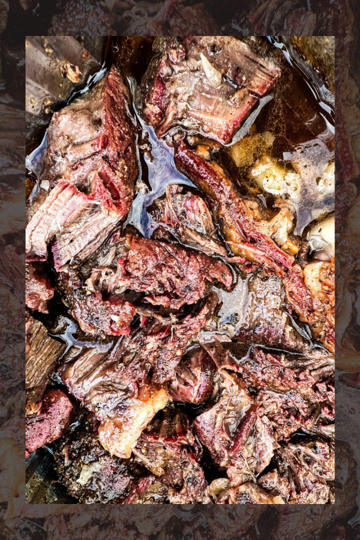 Smoked beef chuck roast will quickly become one of your favorite cuts of beef to smoke with a simple beef rub made with garlic, salt, and pepper and then finished in a pan of onions and beef broth.