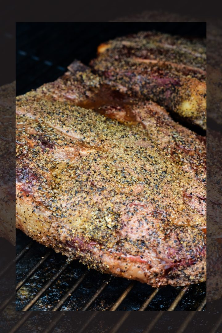 Smoked beef chuck roast will quickly become one of your favorite cuts of beef to smoke with a simple beef rub made with garlic, salt, and pepper and then finished in a pan of onions and beef broth.