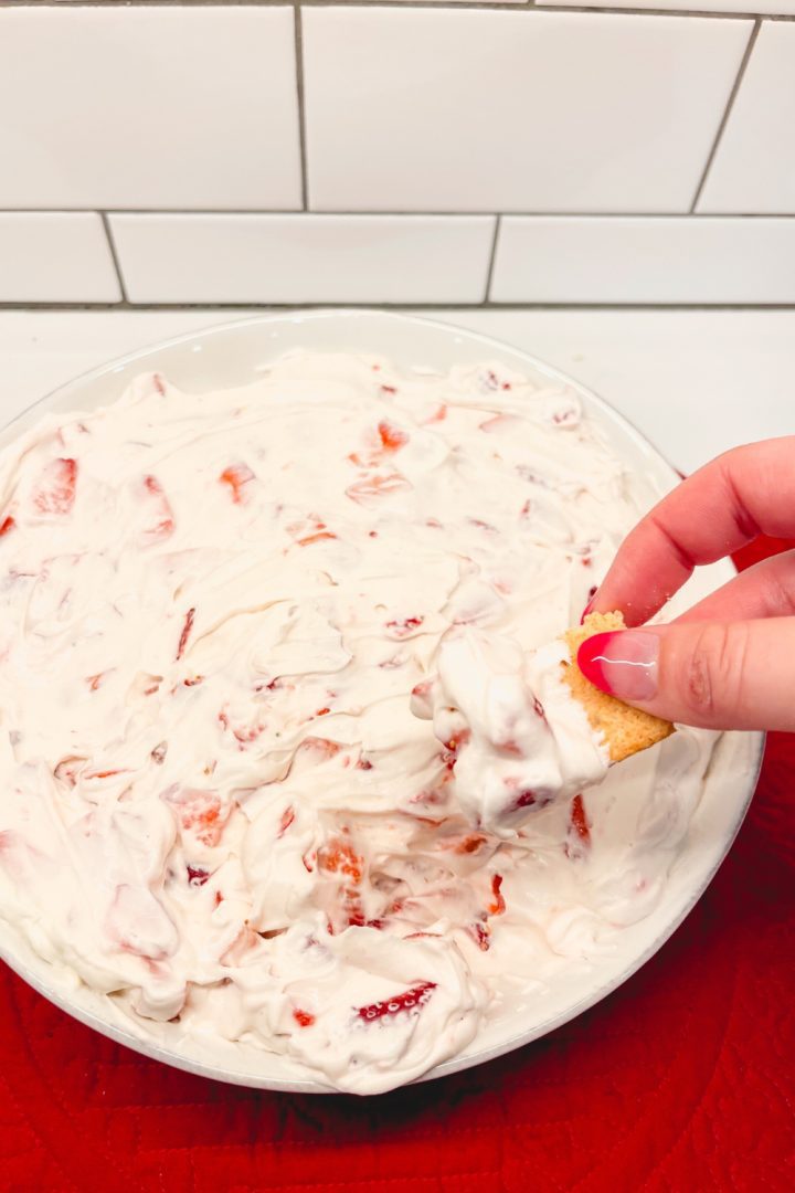 Strawberry Cheesecake Dip is a no bake cheesecake dessert made with cream cheese, whipped cream, powdered sugar, and fresh strawberries.