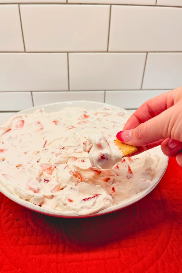 Strawberry Cheesecake Dip is a no bake cheesecake dessert made with cream cheese, whipped cream, powdered sugar, and fresh strawberries.