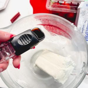 Begin by adding the softened cream cheese and vanilla to a medium-sized bowl and begin by using a hand mixer or a whisk to beat until it's velvety smooth and free of lumps.