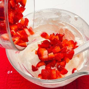 Fold in the diced fresh strawberries. Their juicy, vibrant nature will provide bursts of sweetness and a delightful contrast to the creamy base.