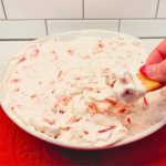 Fold in the diced fresh strawberries. The juicy strawberries provide bursts of sweetness and a delightful contrast to the creamy base.