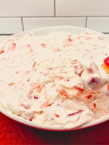 Strawberry Cheesecake Dip is a no bake cheesecake dessert made with cream cheese, whipped cream, powdered sugar, and fresh strawberries.