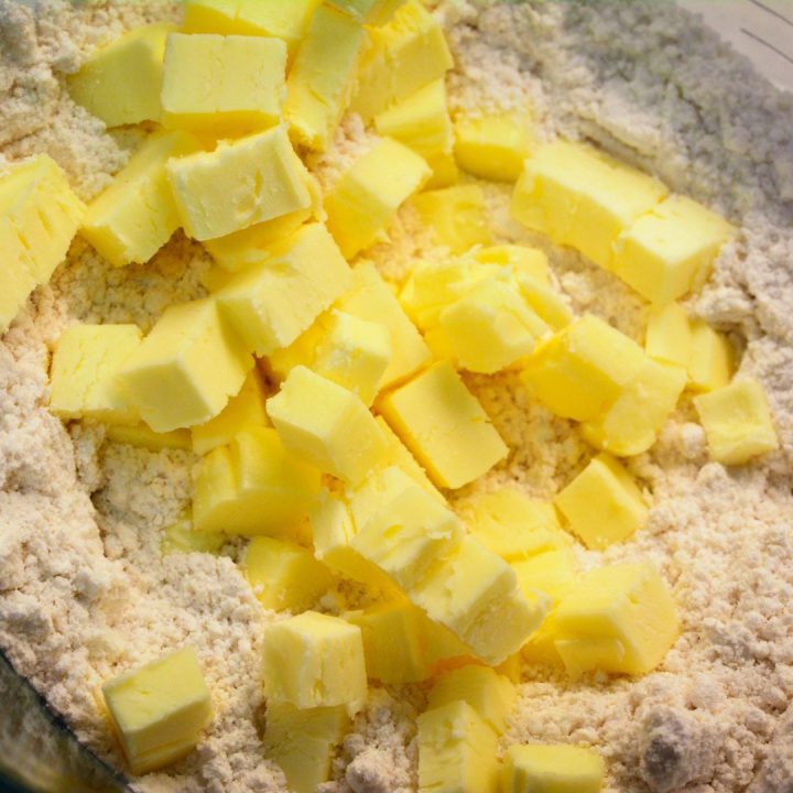 Dump the biscuit mix in a large mixing bowl and then add the cold butter, diced into small pieces or cubes. You can also grate the butter.