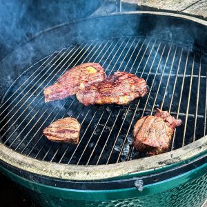 After searing, move the steaks to the medium-heat side of the grill. Close the lid and continue cooking for approximately 5-7 minutes for medium-rare, or adjust the time for your preferred level of doneness.