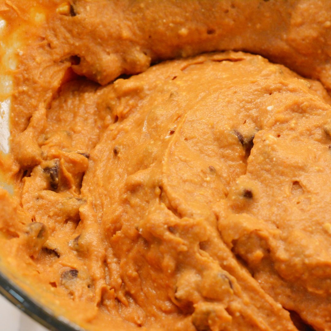 Add the chocolate chips to the pumpkin muffin batter.