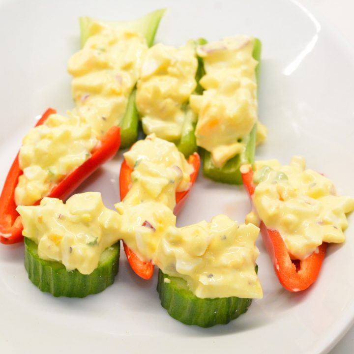 Carefully stuff each celery stalk, mini sweet pepper half or even cucumber disk with a generous spoonful of the egg salad. You want it to bulge slightly from the top to give it that eerie appearance.