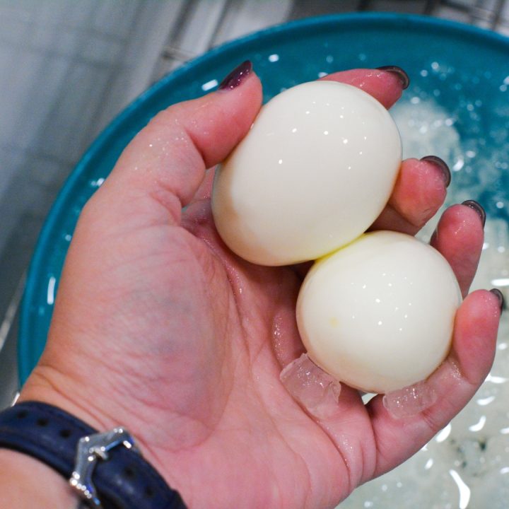 Then, crack the eggs by shaking them in the steamer, transfer the eggs to a bowl of ice water, and let them cool for a few minutes. 